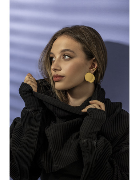 Złote kolczyki blaszki w kształcie koła ze stali szlachetnej o błyszczącym wykończeniu.